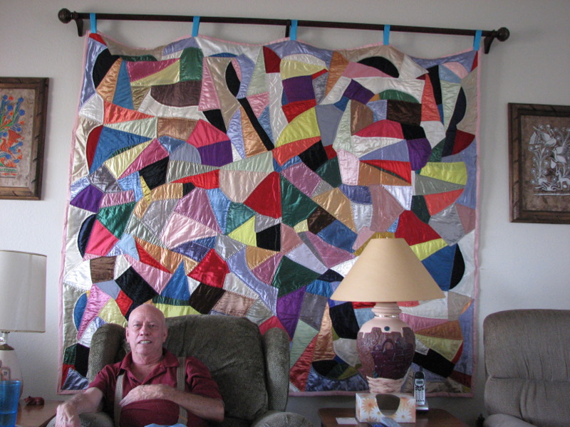 2007-07-29 A.J. sits in front of Mildred's 'crazy quilt' on display in his and Betty's home in Silver City